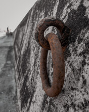 Closeup Shot Of A Old Rusty Ring Connected To A Stone Wall