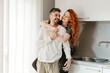 © ADDICTIVE STOCK - Happy loving couple hugging in kitchen