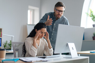 Poster - Frustrated male boss scolding young secretary for making mistake in business project at corporate office