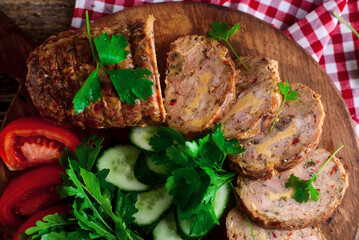 Canvas Print - Chicken roll with cheese and vegetables sliced, on a wooden board.rustic style.selective focus