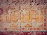 Closeup shot of an ancient painting with bas-reliefs made on the wall in Egypt