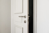 White bathroom door slightly open or left ajar