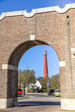 Den Helder, Netherlands, April 2022. The Gatehouse And The Huisduinen Lighthouse In The Background.