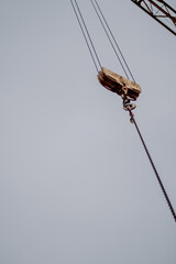 Canvas Print - Vertical shot of a construction crane hook against gloomy sky