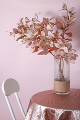 Poster - Vertical shot of  decorative flowers on a vase isolated on a pink background