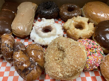 Closeup Shot Of Various Doughnuts With Different Toppings, In A Box