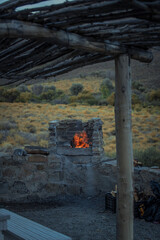 Poster - Vertical shot of a stone fireplace with burning fire