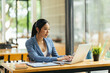 © PaeGAG - Portrait of Asian young female working on laptop and financial report at office.