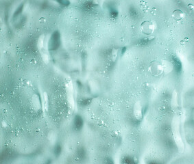 green transparent gel texture filled with air bubbles. development of cosmetics. research in cosmeto