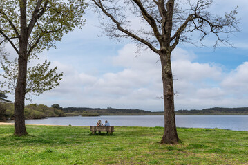 Two women sitting on the Pond of Leon. Natural Reserve of the Courant d'Huchet