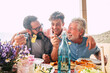 © simona - Father grandfather and son eaing together having fun. father's day concept celebration with men family enjoying meal on the table. Cheerful man young adult and mature laughing and having lunch