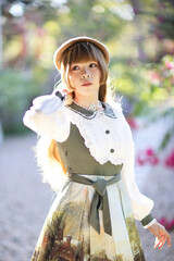 A beautiful woman in lolita dress in garden background Japanese street fashion portrait