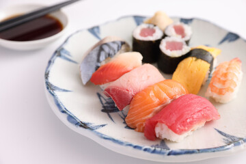 Wall Mural - Sushi Set nigiri and sushi rolls with soy sauce and chopsticks Japanese food isolated in white background