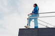 © Dani D.G - Young businesswoman, on top of a skyscraper looking at the horizon. Concept of feminism, success, strength, businesswoman, new generations, tenacity and courage. copy space