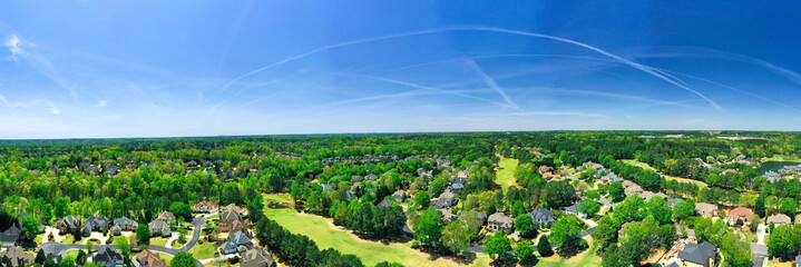 Wall Mural - 180 degree Aerial panoramic view of house cluster in a sub division in Suburbs with golf course and lake in metro Atlanta in Georgia ,USA shot by drone shot during golden hour