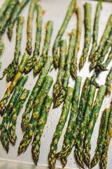 Wall Mural - asparagus on baking sheet ready to be roasted in the oven