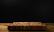 Wooden board for cutting on a black background.