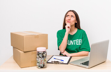 Poster - hispanic pretty woman thinking, feeling doubtful and confused. donations volunteer