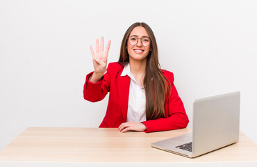 Wall Mural - hispanic pretty woman smiling and looking friendly, showing number four.  business and desk concept