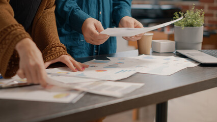 Poster - Close up of colleagues analyzing data rate charts on papers to plan business project. Team of people working on marketing presentation and analysis while looking at documents and laptop.