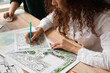 © Pixel-Shot - Young female landscape designer working in office