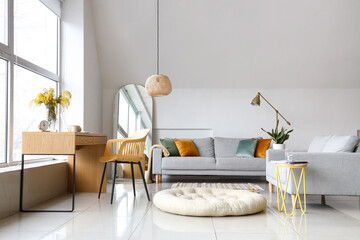 Poster - Vase with mimosa flowers on table and sofa in interior of living room