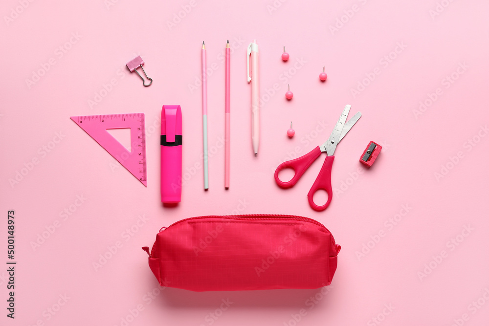 Pencil case with school stationery on pink background, top view
