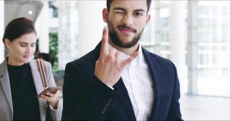 Poster - Having the right attitude in business is important. Handsome confident mixed race young business man gesturing the rock on hand sign while walking through office corridor in a modern convention centre