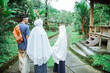 © Odua Images - back portrait of muslim family with kid walking while wearing hijab and islamic traditional clothes to go to the mosque