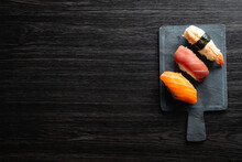 Nigiri Sushi On Wood Table In A Japanese Restaurant. Copy Space And Top View