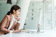 © makibestphoto - Attractive Asian office worker person sitting at desk and looking to monitor.