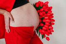 Background With Pregnant Belly In Red Tones With Flowers