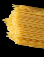 Wall Mural - Dried long pasta isolated on black background.