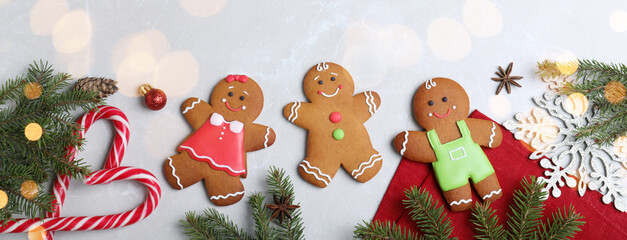 Flat lay composition with gingerbread cookies on light grey marble table. Banner design