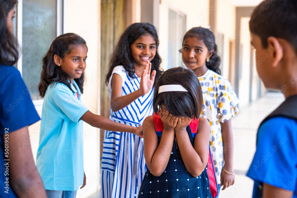 Group of children buylling girl kid by surrounding at school corridor ...