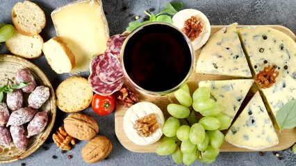 Canvas Print - composition with red wine, cheese and salami on wooden board