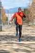 © 2Design - Front view of senior man in sport clothes jogging in a city park in a sunny day
