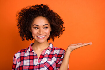 Photo of millennial wavy lady look promo wear red shirt isolated on orange color background