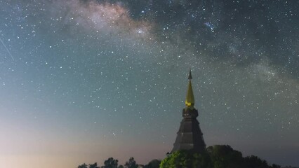 Wall Mural - time lapse 4k of star trails moving over a sacred temple at doi inthanon national park, chiang mai, 