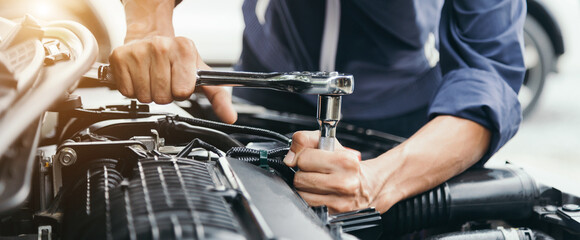 Automobile mechanic repairman hands repairing a car engine automotive workshop with a wrench, car service and maintenance,Repair service.