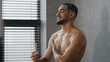 Muscular Arabian sexy naked male Indian model sportsman guy 30s handsome relaxing bare wet man washing in bathroom with liquid soap shower gel foam water casual refreshment wash skincare body care