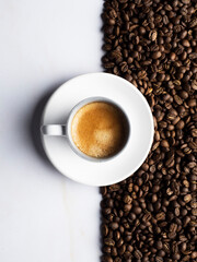 cup of coffee with beans and a white background