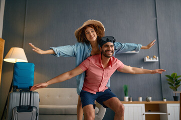 Wall Mural - Happy couple having fun before honeymoon vacation