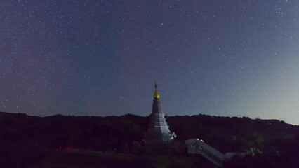 Wall Mural - time lapse 4k of the starry night moving over a sacred temple at doi inthanon national park, chiang 