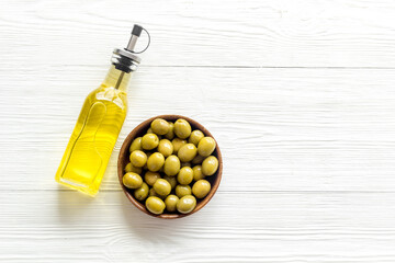 Wall Mural - Olive oil in bottle with green olives. Cooking oil background