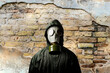 Gas mask. Man wearing a gas mask on his face and the wall behind him with copy space.
