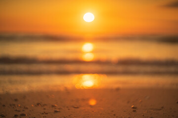 Wall Mural - blur tropical beach with smooth wave and sunset sky abstract background. copy space of business summ