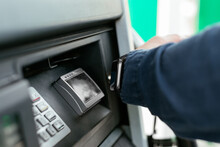 Anonymous Person Paying With Card At Machine In Modern Petrol Station
