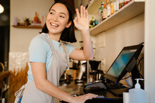Asian Barista Woman Gesturing While Working With Cash Register
