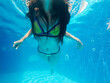 Underwater woman close up portrait in swimming pool.